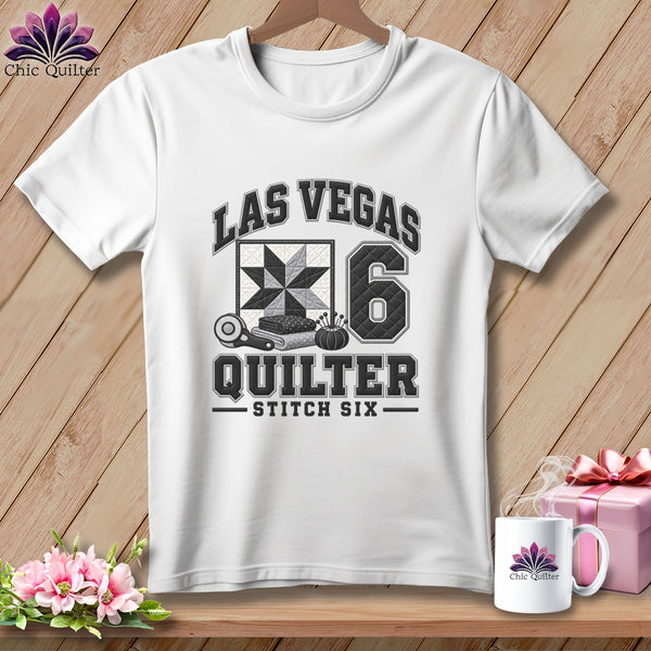 A white t-shirt features a black and gray design reading Las Vegas Quilter Stitch Six.
