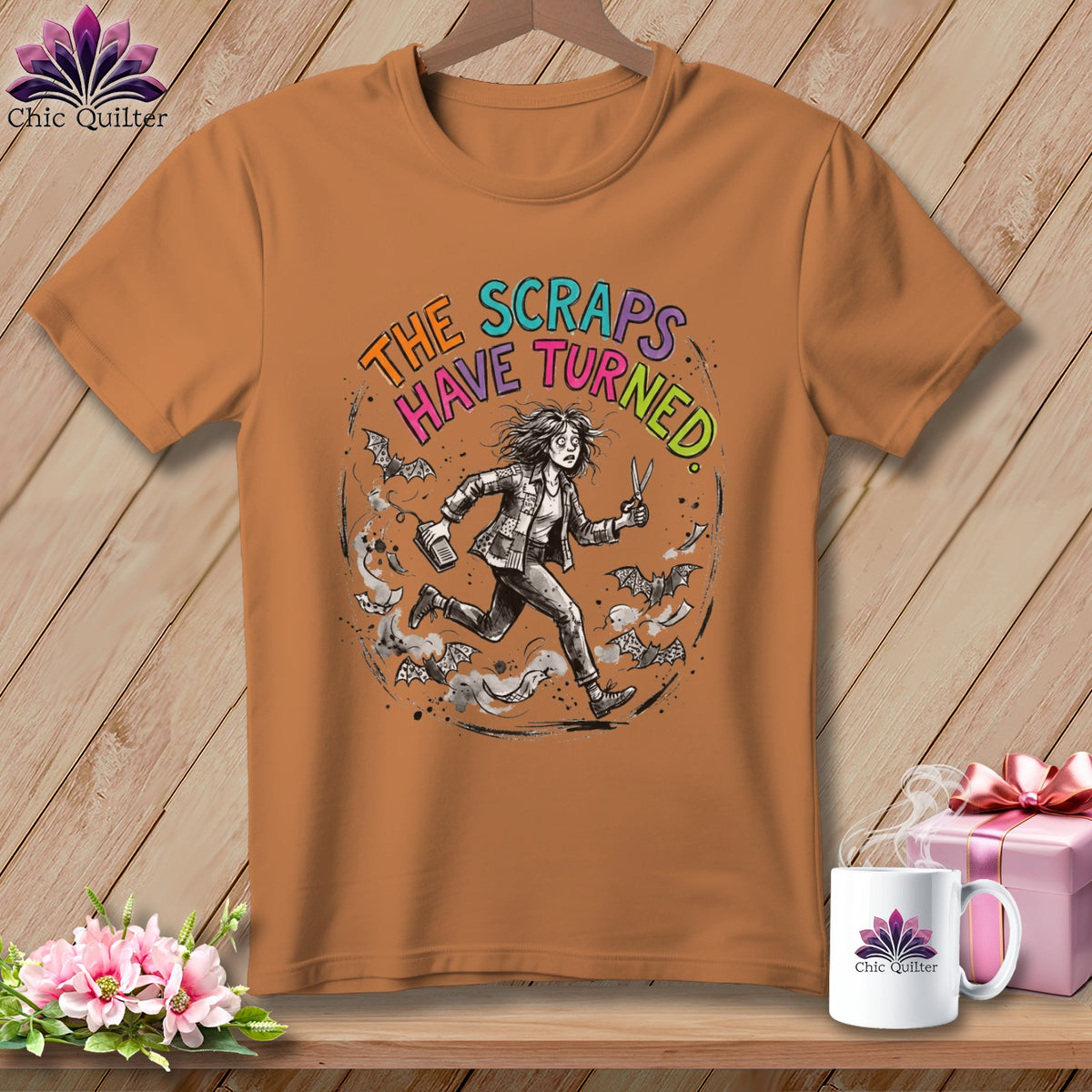 Orange t-shirt with distressed graphic: "The Scraps Have Turned" and a running person.