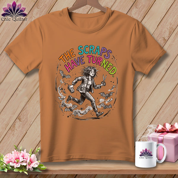 Orange t-shirt with distressed graphic: "The Scraps Have Turned" and a running person.