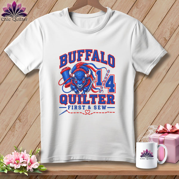 White t-shirt featuring a blue and red buffalo graphic, the text BUFFALO QUILTER FIRST AND SEW, and sewing-themed elements.