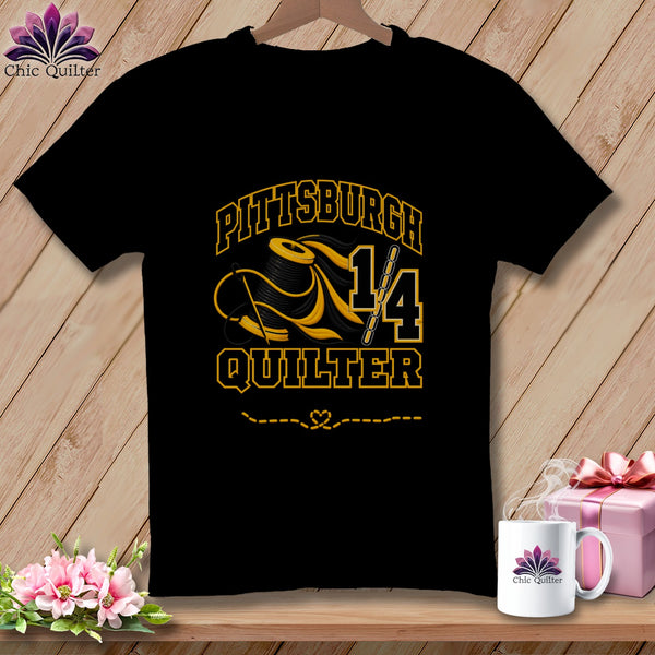 Black t-shirt featuring a yellow and black graphic with the text Pittsburgh Quilter, a spool of thread, and a needle.