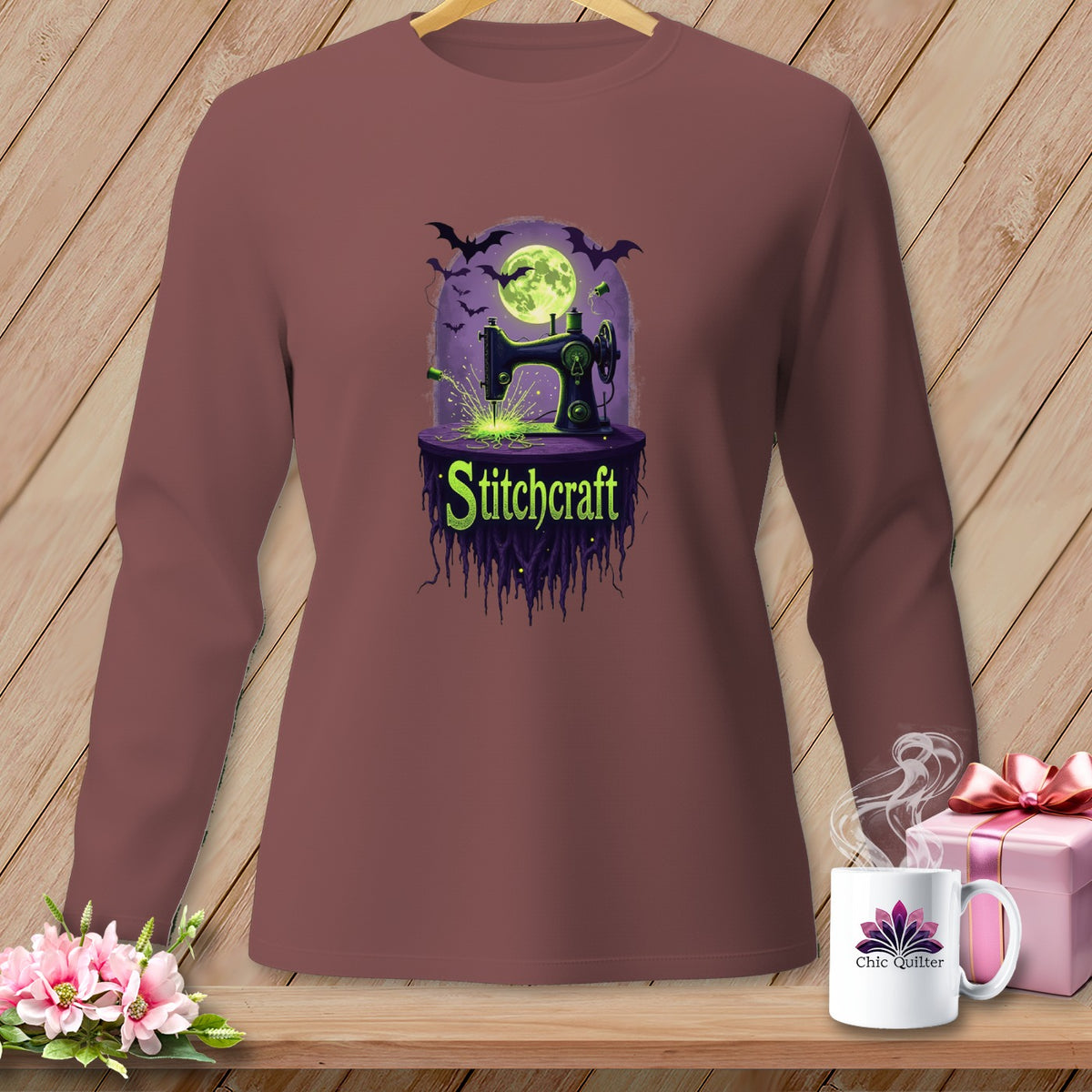 Brown long-sleeve shirt with a Halloween-themed graphic of a sewing machine and bats.
