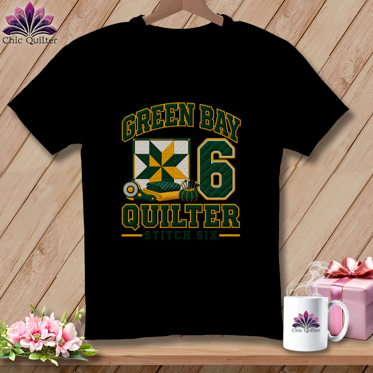 Black t-shirt featuring Green Bay Quilter text, a quilt block graphic, and the number six on a wooden background.