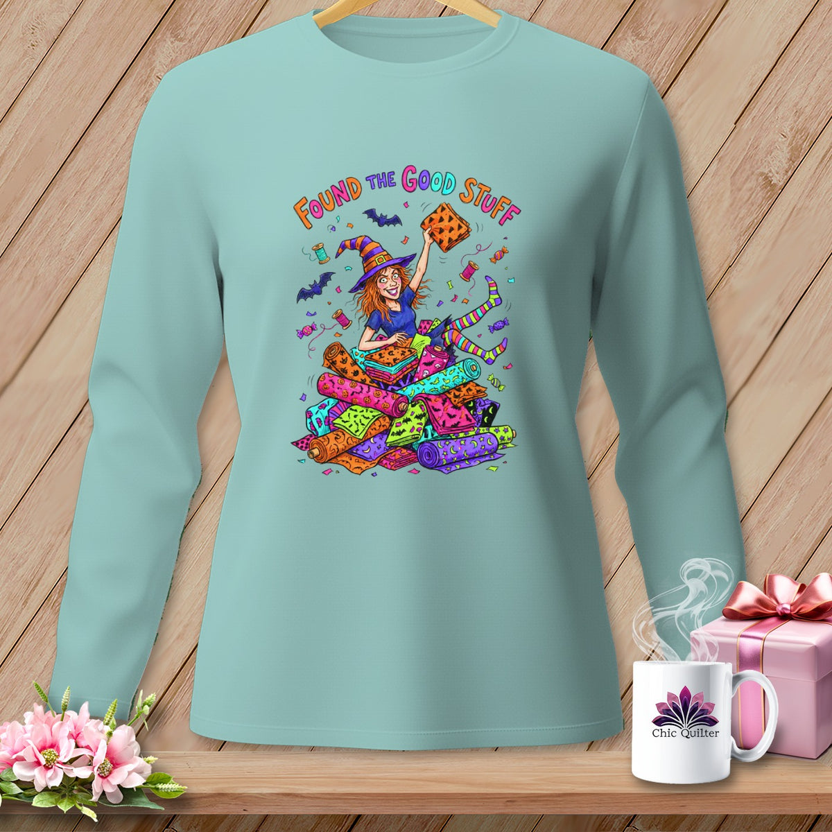 Light blue long-sleeve shirt with cartoon witch and Halloween fabric rolls.
