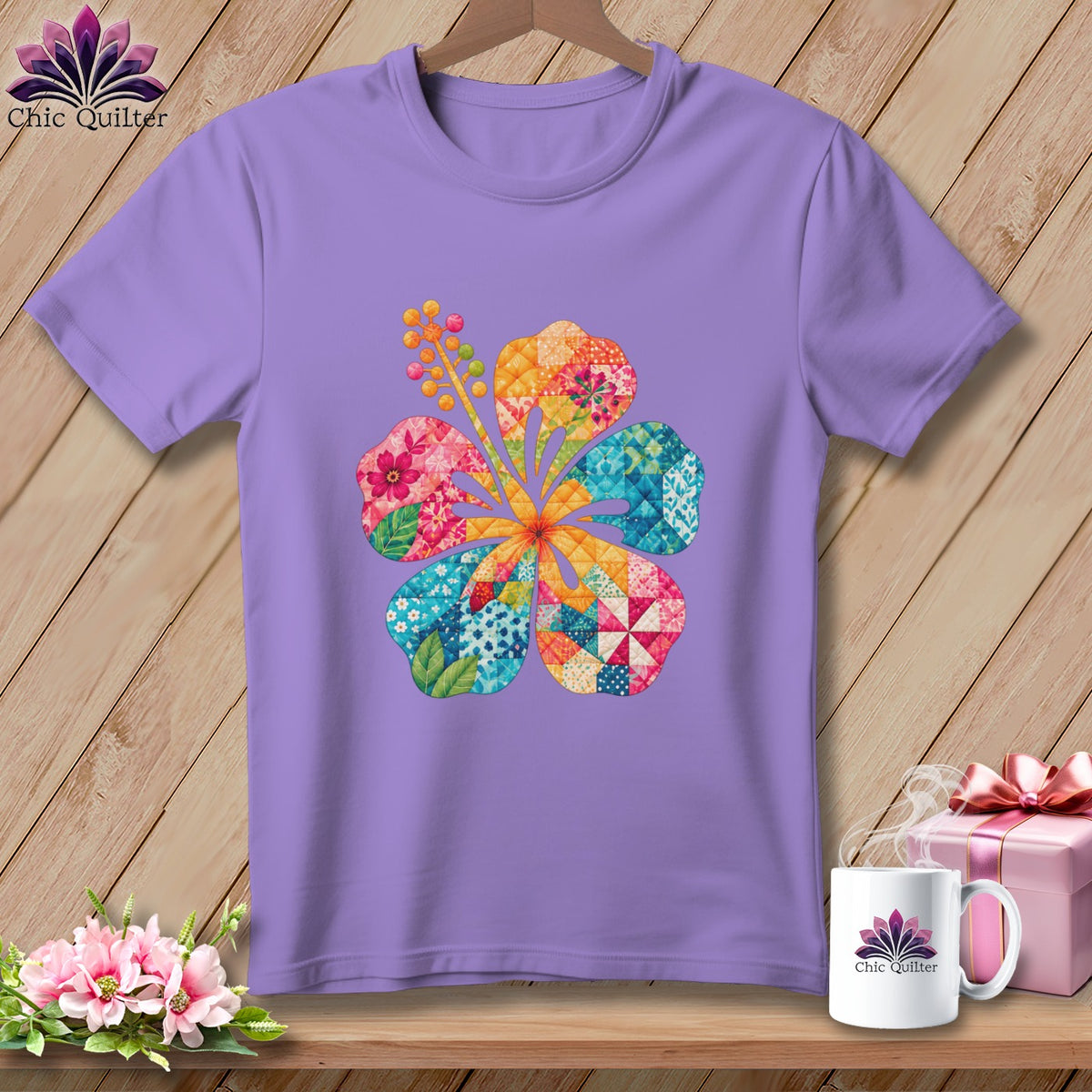 A light purple crewneck t-shirt featuring a colorful patchwork hibiscus flower graphic on the chest.