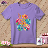A light purple crewneck t-shirt featuring a colorful patchwork hibiscus flower graphic on the chest.