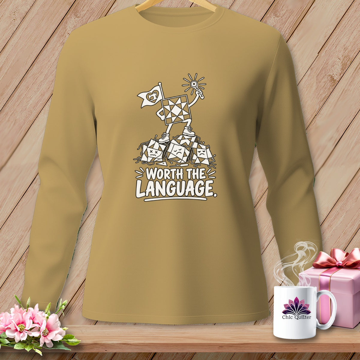 Brown long-sleeve shirt with a graphic of a quilt block character standing on sad quilt blocks, text "Worth the Language."