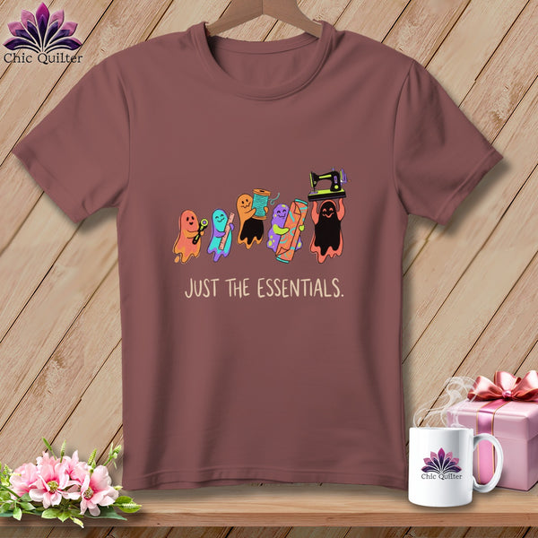 T-shirt with colorful sewing ghosts holding scissors, thread, ruler, fabric, and sewing machine. Text reads "JUST THE ESSENTIALS."