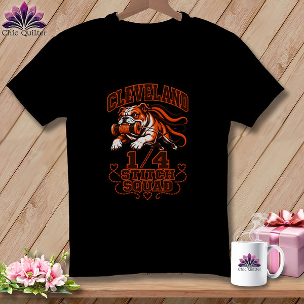 A black t-shirt featuring an orange graphic of a bulldog holding a spool of thread with the text Cleveland 1/4 Stitch Squad.