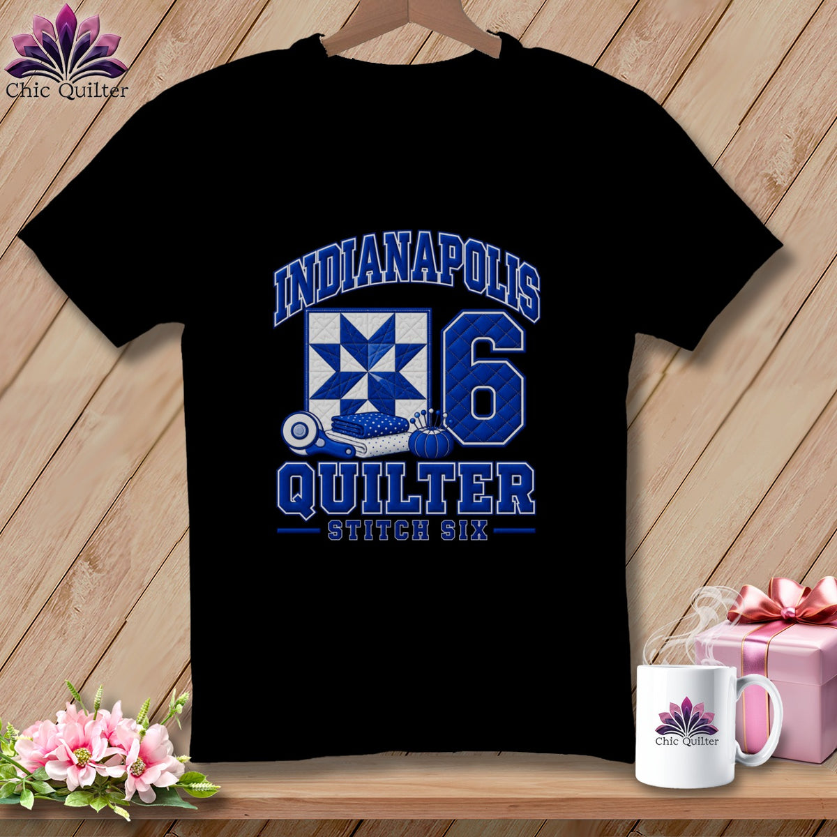 A black t-shirt features blue text reading Indianapolis Quilter Stitch Six, a quilt block, and the number six.