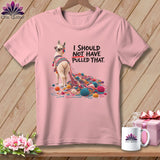 Pink t-shirt with a llama tangled in yarn and text that reads 