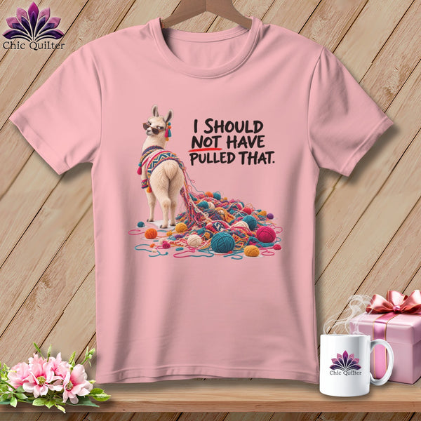 Pink t-shirt with a llama tangled in yarn and text that reads "I SHOULD NOT HAVE PULLED THAT."