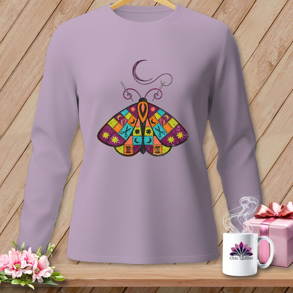 Lavender long-sleeve shirt with a colorful patchwork butterfly and sewing motifs.