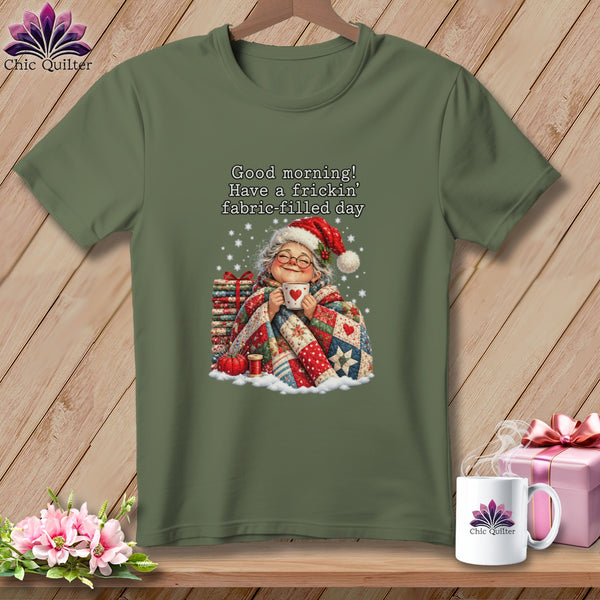 An olive green t-shirt displays text and a graphic of an elderly woman holding a mug.