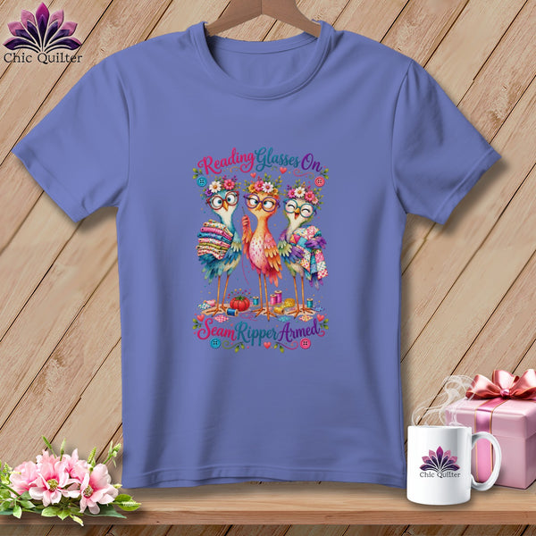 Periwinkle t-shirt featuring three whimsical birds wearing glasses and flower crowns, with sewing-themed text.