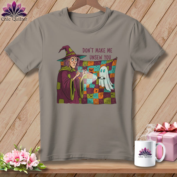 T-shirt with witch holding a flashlight on a colorful patchwork blanket with a ghost.