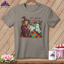 T-shirt with witch holding a flashlight on a colorful patchwork blanket with a ghost.