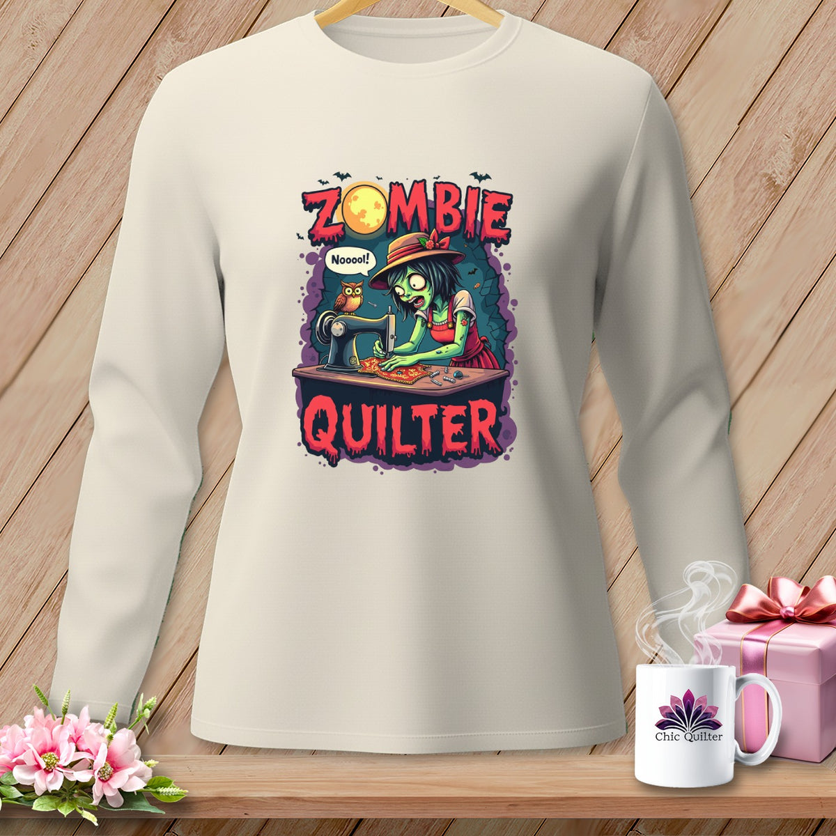 Zombie quilter graphic with text "Zombie Quilter" on a cream long-sleeve shirt.