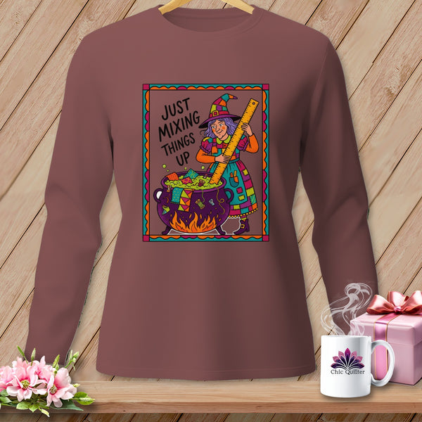 Witch stirring cauldron with text "JUST MIXING THINGS UP" and quilt-like accessories.