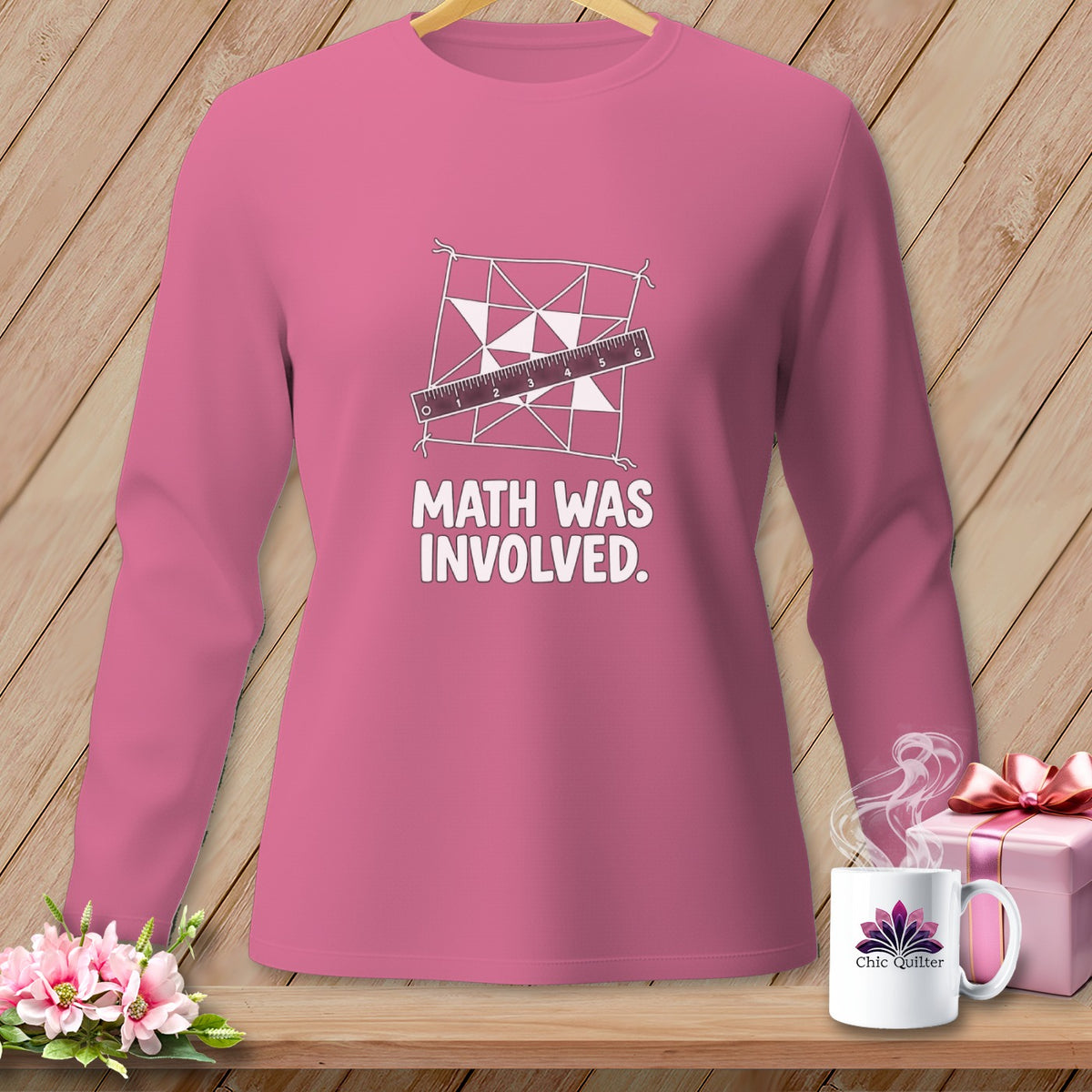Pink long-sleeved shirt with quilting pattern, ruler, and text "MATH WAS INVOLVED."