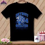 A black t-shirt featuring a blue lion design, the text Detroit Quilter, and sewing graphics.