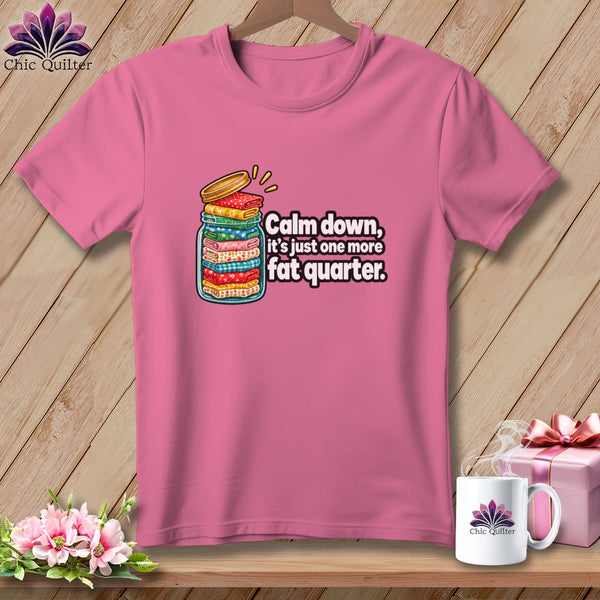 Pink short-sleeve t-shirt with a graphic of a glass jar filled with folded fabric and text reading "Calm down, it's just one more fat quarter."