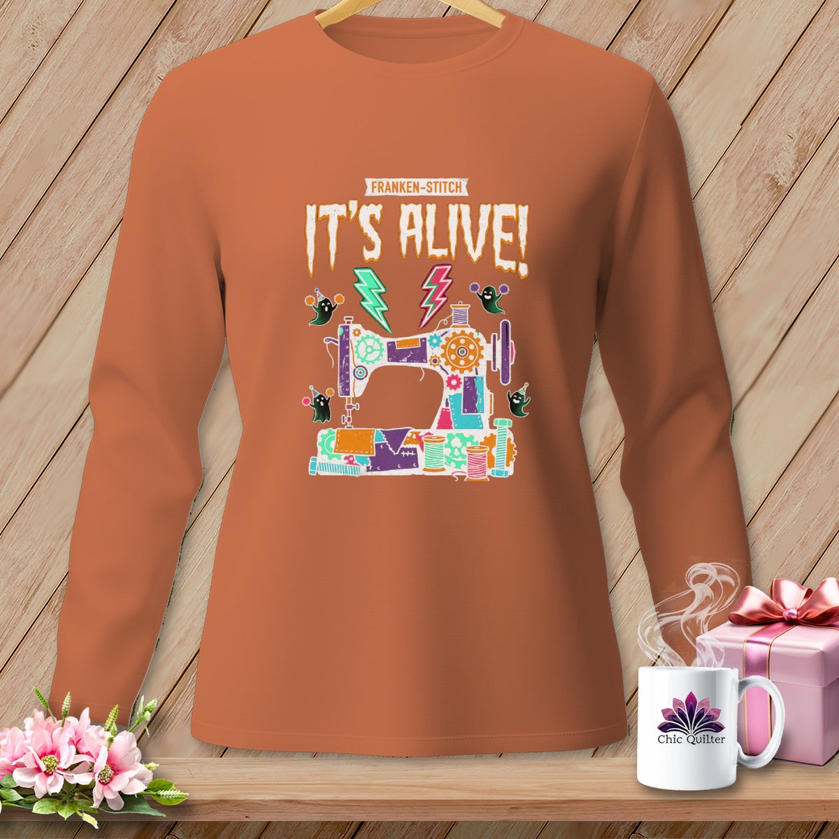 Orange long-sleeved shirt with a "Franken-Stitch" sewing machine design and "IT'S ALIVE!" text.