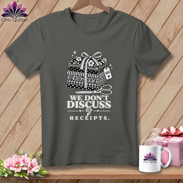 Gray t-shirt with stack of fabric, measuring tape, scissors, and "We Don't Discuss Receipts" text.
