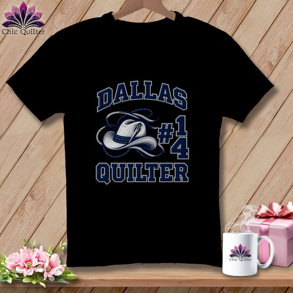 A black t-shirt displays white and blue text reading Dallas Quilter with a cowboy hat and needle graphic.