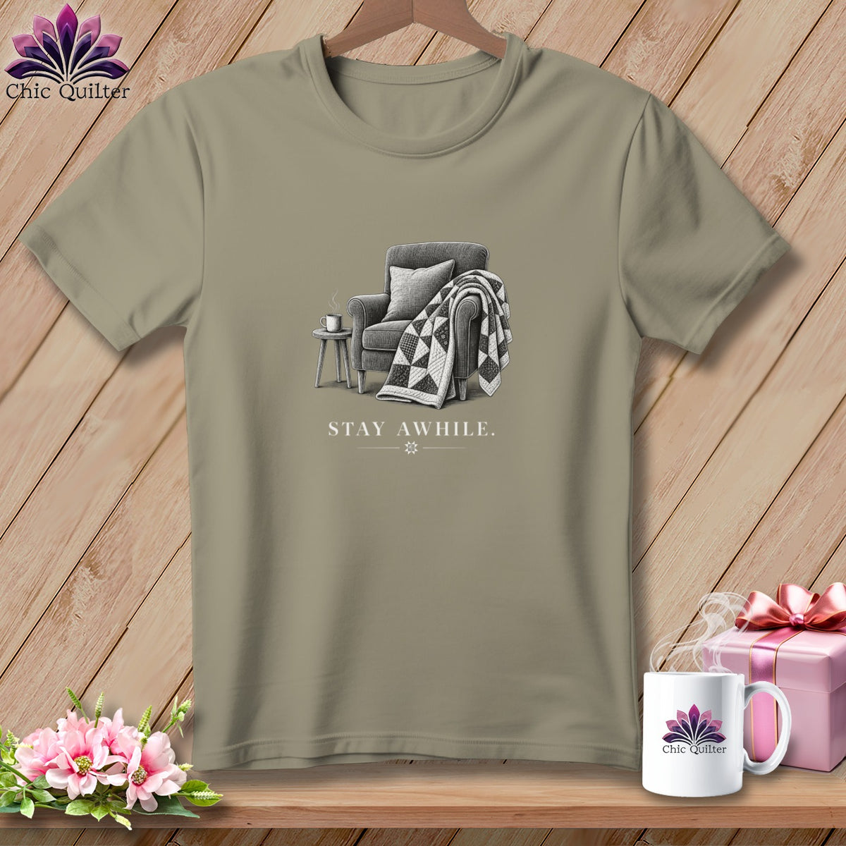 T-shirt graphic of armchair, quilt, and "STAY AWHILE." text.