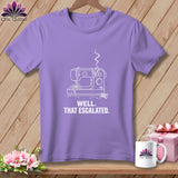 Purple t-shirt with white line drawing of a sewing machine and text.