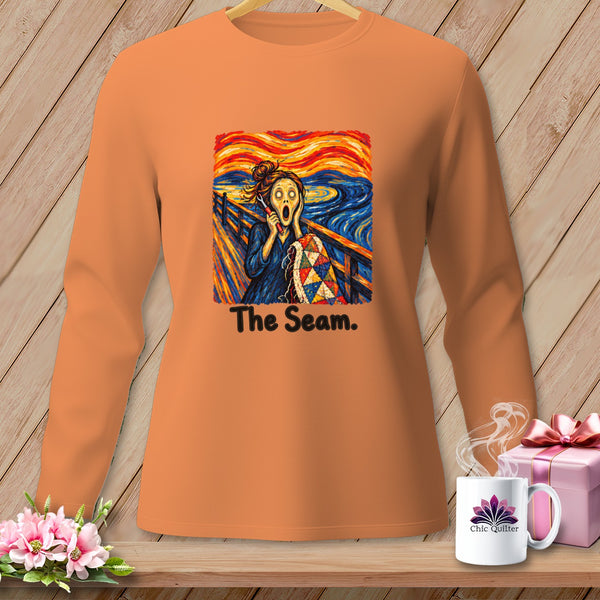Orange long-sleeve shirt with "The Seam" graphic featuring Edvard Munch's "The Scream" and a quilt.