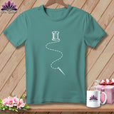 Teal t-shirt with white spool of thread, needle, and dashed line design.