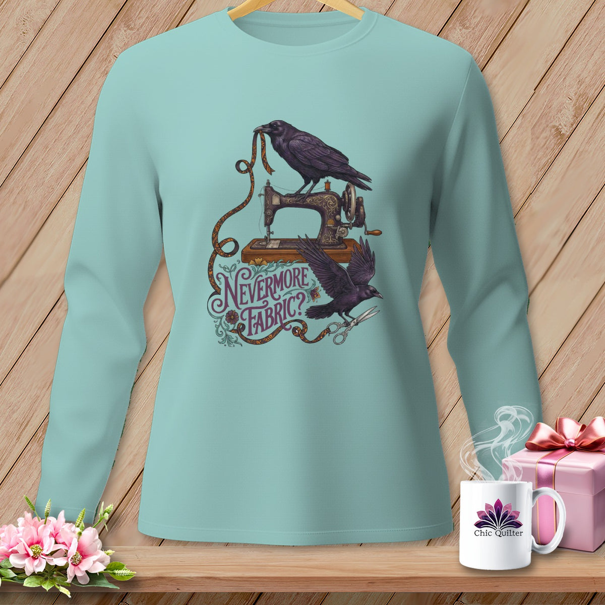 Light blue long-sleeve shirt with ravens, sewing machine, and "Nevermore Fabric?" text.