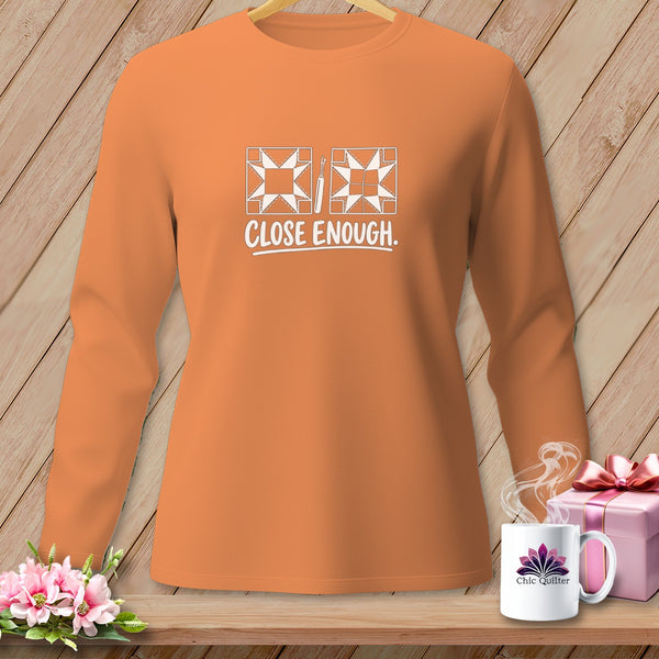 Orange long-sleeved shirt with quilting graphic and text "CLOSE ENOUGH".