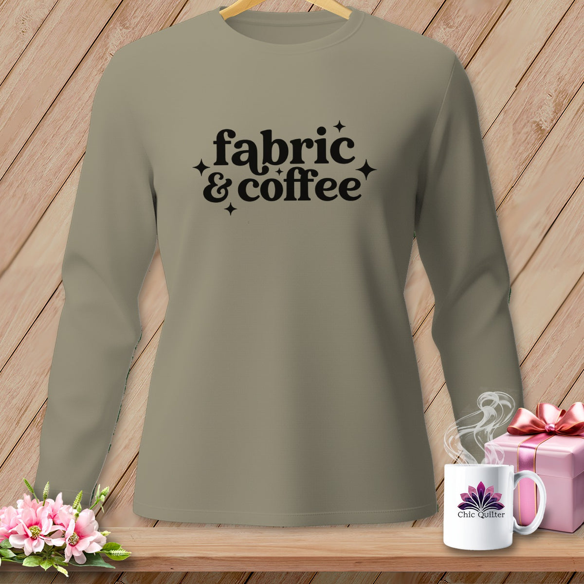 Grey long-sleeve shirt with "fabric & coffee" text, pink gift, and mug.