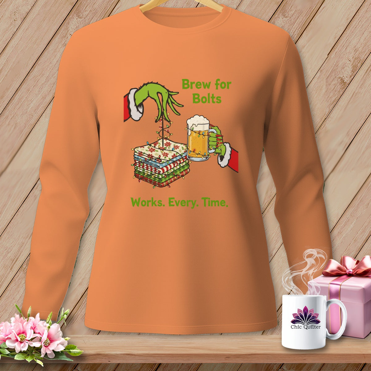 Grinch's hand holding beer and fabric with text "Brew for Bolts Works. Every. Time."