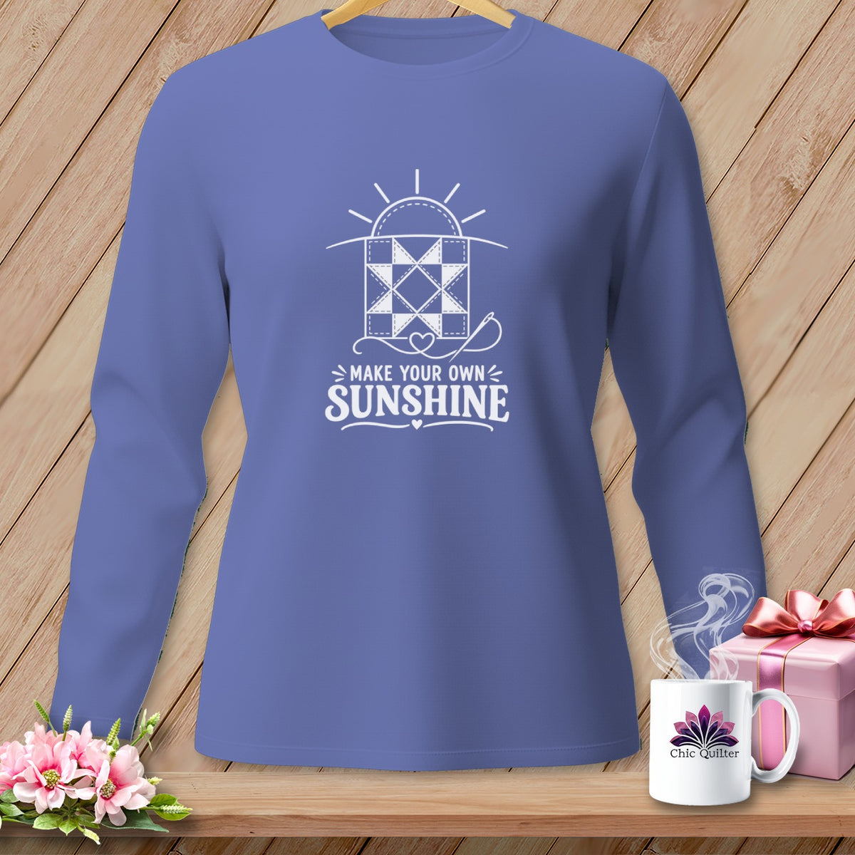 Periwinkle long sleeve shirt with "Make Your Own Sunshine" quilting graphic.
