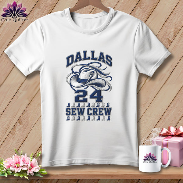 White t-shirt featuring a blue graphic of a cowboy hat with text Dallas 24 Sew Crew.