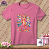 Pink t-shirt featuring an illustration of three colorful cartoon birds sewing, surrounded by crafting supplies.