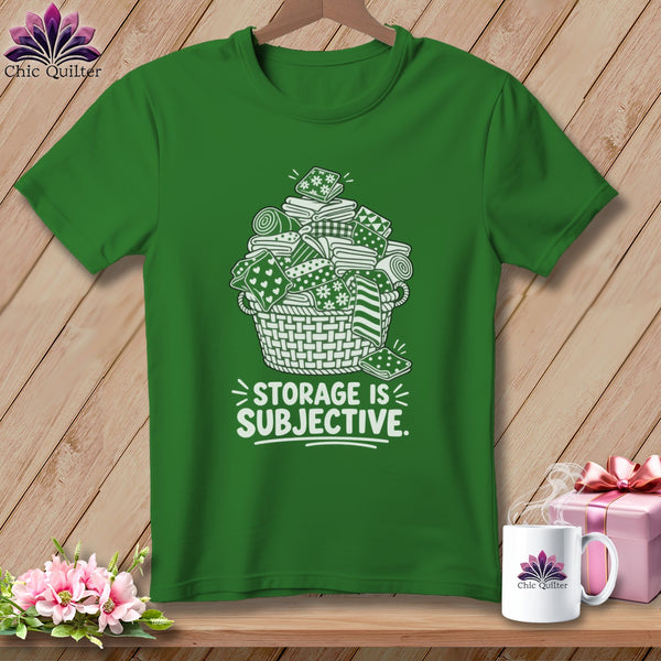 Green t-shirt with a white illustration of fabric in a basket and the text "STORAGE IS SUBJECTIVE."