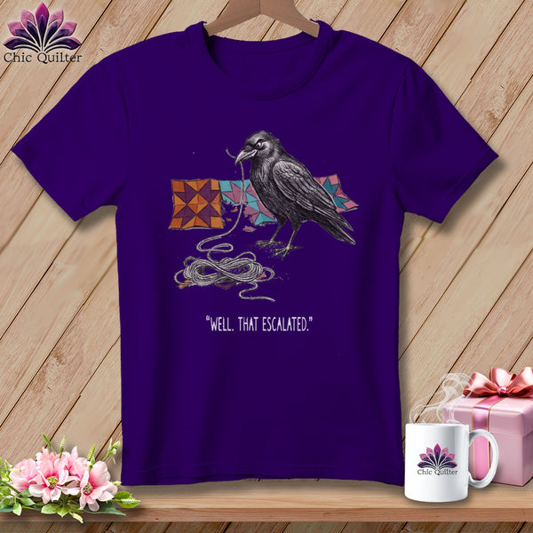 Purple t-shirt with a crow tangled in string and quote "Well, That Escalated."