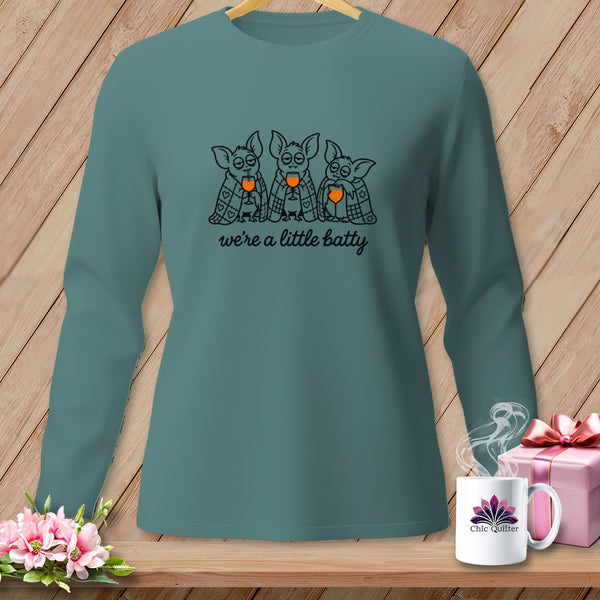 Teal long-sleeve shirt with three cartoon bats drinking from glasses, saying "we're a little batty".