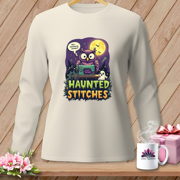 Light cream long-sleeve shirt with a Halloween graphic of an owl sewing and "Haunted Stitches" text.