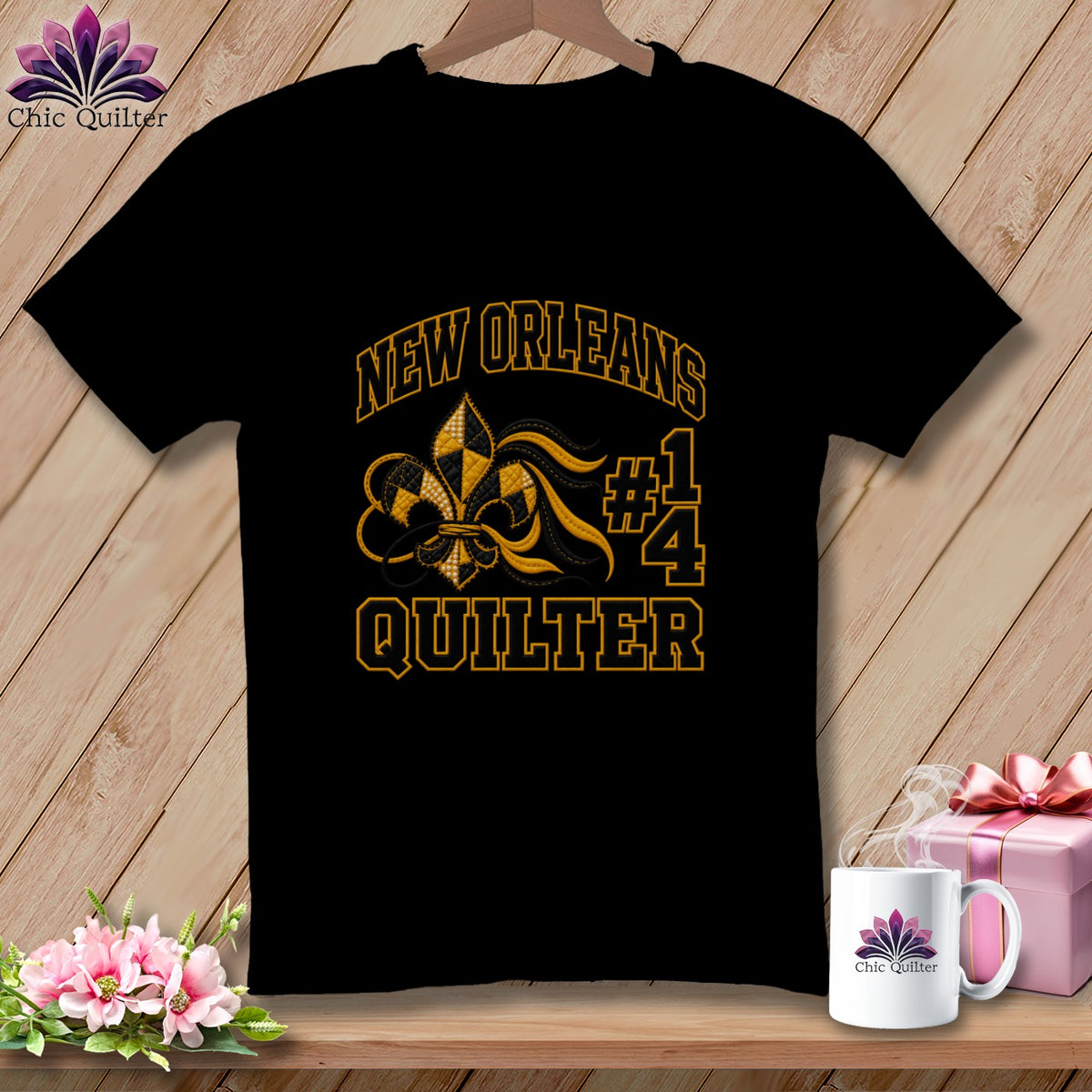 Black t-shirt featuring a New Orleans Quilter graphic, with gold text and a fleur-de-lis.