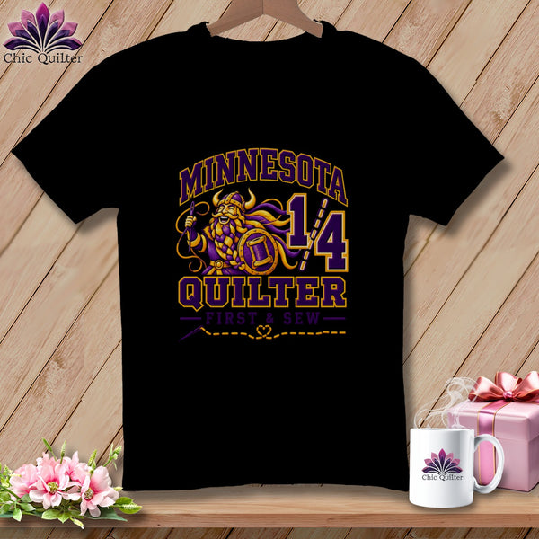Black t-shirt featuring a purple and yellow Minnesota Quilter graphic with a Viking design.