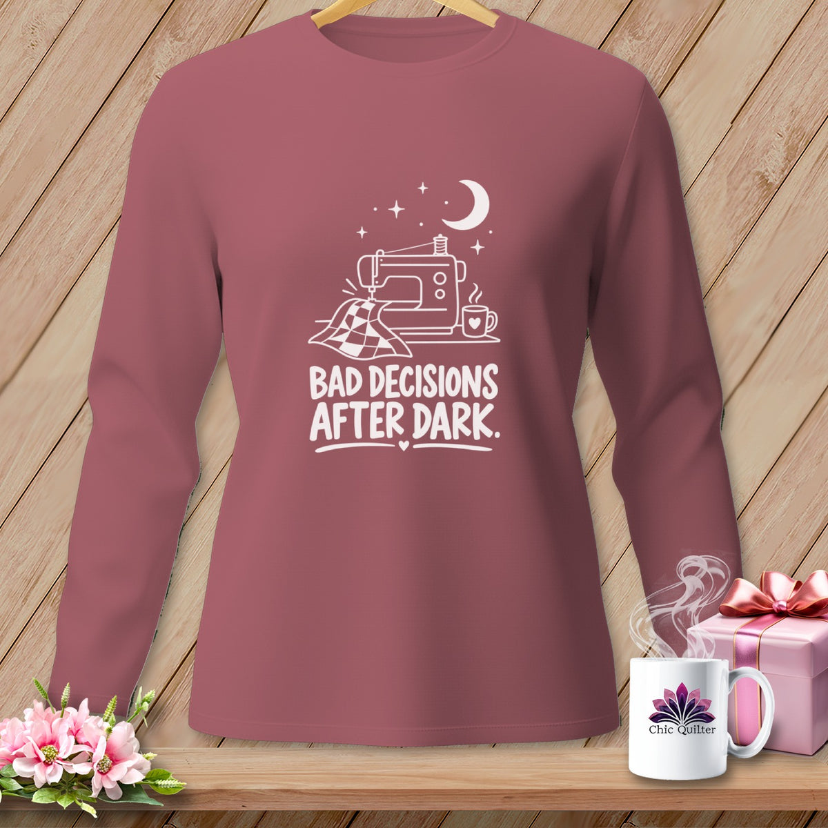 Pink long-sleeve shirt with a sewing machine and the text "Bad Decisions After Dark."