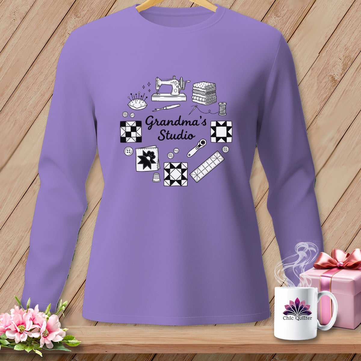 Purple long-sleeve shirt with sewing and quilting graphics, text "Grandma's Studio".