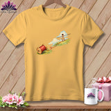 Mustard yellow crewneck t-shirt featuring a graphic of a woman tightrope-walking on red thread from a wooden spool.