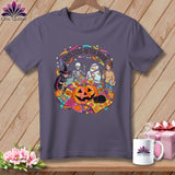 T-shirt graphic of Halloween characters sewing and reading, with text 